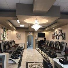 a hair salon with lots of chairs and lights