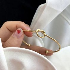 Tie The Knot Bracelet, Gold Filled Friendship Knot Bracelet, Wire Cuff Solid Bridesmaid Gift Style: Handmade, Solid Color Design: Asymmetrical, Plating Pattern: Knot Material: Stainless Steel Occasion: Daily Quantity: 1 Piece Classification: Cuff Bracelets Pendant Material: Brass Plating Material: 18k Gold Plated Weight: 8g Measurements: Please See Photo. With Its Minimalist Yet Refined Aesthetic, The Gold Knot Bangle Bracelet Exudes Understated Glamour, Making It A Perfect Choice For Everyday W Friendship Knot, Gold Knot Bracelet, Knot Bracelets, Knot Bangle, Adjustable Knot, The Bangles, Knot Bracelet, Bridesmaid Bracelet, Girls Jewelry