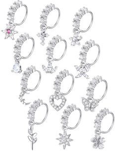 twelve pairs of silver plated ear rings with crystal stones and stars on each side