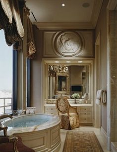 a fancy bathroom with an oval tub and large windows