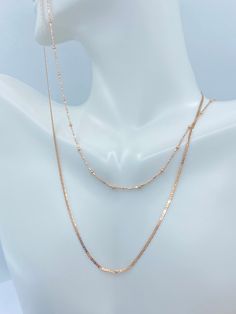 Solid 10K White Gold Rope Chain. This classic Rose Gold Gold Necklace is a must have in your jewelry collection. Makes an amazing Christmas gift for anyone. Layer perfectly with other necklaces. Premium Lobster Hook for added safety! Details: * Material: 10K Rose Gold * Pattern: Rope, Flat Mariner, Ball Station * Length: 16in, 18in 20in Rope Chain Width: 2mm Ball Chain Width: 1.8mm(ball) 1mm(Chain) Mariner : 1.3mm Arrives in a GIFT BOX and includes FREE SHIPPING within the USA. International Shi Fine Jewelry Rose Gold Chain Necklace With Adjustable Chain, Rose Gold Adjustable Chain Necklace In Fine Jewelry Style, Rose Gold Chain Necklace With Adjustable Chain, Rose Gold Adjustable Chain Necklace, Classic Rose Gold Chain Necklace With Delicate Chain, Classic Rose Gold Delicate Chain Necklace, Classic Delicate Rose Gold Chain Necklace, 14k Rose Gold Chain Necklace With Adjustable Chain, 14k Rose Gold Clavicle Chain Necklace