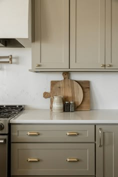 a wooden cutting board sitting on top of a kitchen counter