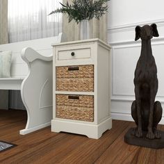 a dog statue sitting on top of a wooden floor next to a white table with drawers