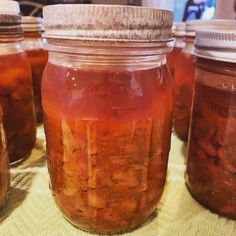 several jars filled with food sitting on top of a table