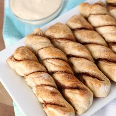 some bread sticks are on a white plate