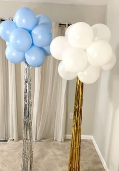 two tall vases with blue and white balloons in them