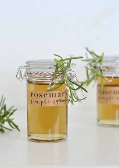 two jars filled with honey sitting on top of a table