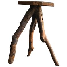 a wooden stool made out of branches on top of a white background with no one around it