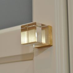 a close up of a door handle with light coming through the top part of it