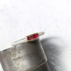 My newest stackable ring features a lovely rectangular raw ruby crystal in a deep red color. Set in rich yellow gold atop a brushed silver band to bring out contrast. I fabricated this simple design from sterling silver and 22k yellow gold. The rough gemstone is all natural and displays darkness and light. Weight: 0.55ct Measurement: 6.5x3mm Ring shank measures 2x2mm. Size 5.5 or 50.5 or 16 or K 1/2 nangijalajewelry.etsy.com One Of A Kind Fine Jewelry Ruby Rings With Rectangular Stone, Fine Jewelry Ruby Ring With Rectangular Stone, Hand Forged Ruby Ring In Red, Hand Forged Red Ruby Ring, Ruby Gemstone Rings With Rectangular Stone, Ruby Rings With Rectangular Gemstone, Rectangular Ruby Ring Gift, Rectangular Ruby Ring For Gift, Ruby Ring With Rectangular Stone For Anniversary