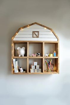 a wooden shelf filled with toys and books