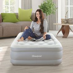 a woman sitting on top of an inflatable bed