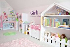 a child's bedroom with toys and bookshelves