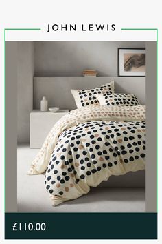 a bed with polka dot sheets and pillows