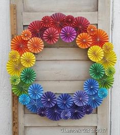 a wreath made out of colorful paper fans