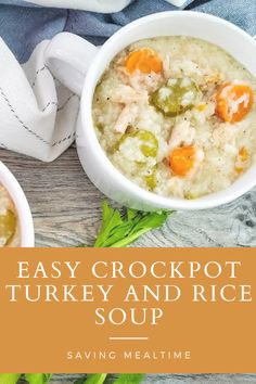 two white bowls filled with turkey and rice soup on top of a wooden table next to carrots