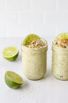 two mason jars filled with oatmeal and limes