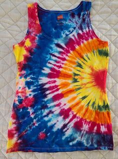 The shirt above is the shirt you will be getting. The size is Woman's Small This is a new, one of a kind handmade tie dye shirt. For quality I use Fruit of the Loom, Hanes Beefy Tee's or Hanes Originals Tee's and they are hand dyed with permanent Procion fiber reactive dyes. This is a Hanes All my products are soaked in soda ash before dyeing, that makes sure the colors are bold and very slow to fade. Recommended Care: All garments are 100% cotton and washed twice before shipping, but may have residual dye - be sure to wash with like colors for the first wash. I suggest they be line dried or ½ tumble on low then line dried the rest of the way( that's what I do) Prolong the life and brightness of your shirt best by washing in cold water . Repeated heat cycles in your washer/dryer can cause Fitted Multicolor Cotton Tank Top, Multicolor Sleeveless T-shirt For Summer, Tie Dye Cotton Tank Top, Tie-dye Cotton Tank Top, Spring Tie Dye Cotton Tank Top, Colorful Hippie Cotton Tops, Multicolor Hand Dyed Tops For Summer, Fitted Tie Dye Cotton Tank Top, Fitted Cotton Tie Dye Tank Top