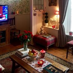 a living room filled with furniture and a flat screen tv sitting on top of a wooden table