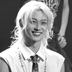 black and white photograph of a woman with blonde hair wearing a shirt and necktie