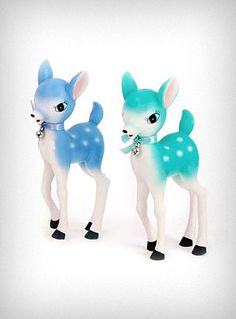 two small plastic deer figurines with blue and white colors