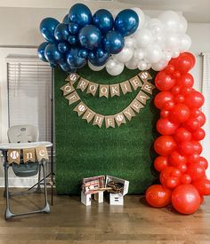 balloons and streamers decorate the entrance to a birthday party