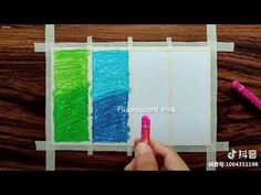 someone is drawing with colored crayons on paper