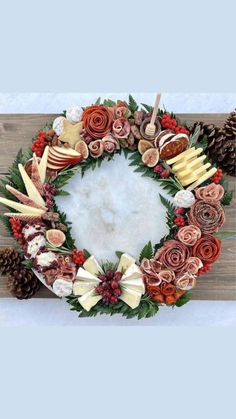 a wreath made out of flowers and pine cones