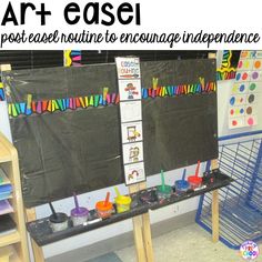 an art easel is set up in the corner of a classroom