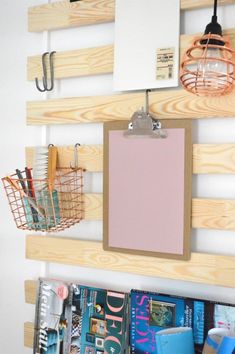 a bulletin board mounted to the side of a wall with clipboards and binders on it