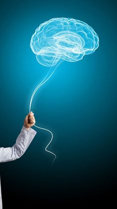 a man in white lab coat holding up a blue light bulb shaped like a brain