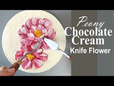 a person is decorating a cake with flowers on it and the words peony chocolate cream knife flower