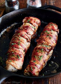 two pieces of meat are cooking in a skillet