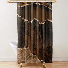 a brown and black shower curtain hanging on a wall next to a white bath tub