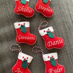 four christmas stockings with name tags on them