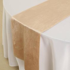 the table is covered with white and gold linens