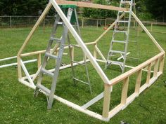 two ladders are attached to the top of a wooden structure in an open field