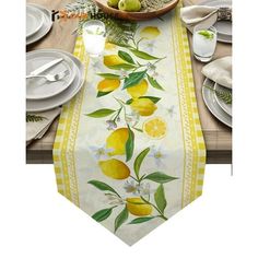 an image of a table setting with lemons and flowers on the table runner in yellow