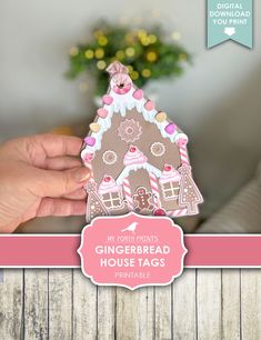 someone holding up a gingerbread house shaped card