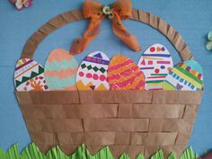 an easter basket made out of paper and decorated eggs