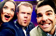 two men and a woman are posing for a photo with one man making a funny face