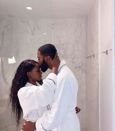 a man and woman embracing in front of a shower