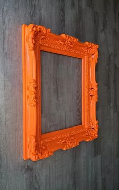 an orange frame hanging on the wall