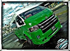 a green van is parked on the street