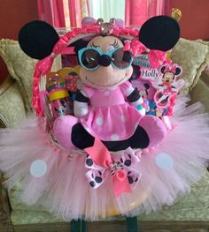 a minnie mouse stuffed animal in a pink tutu with polka dots on it's skirt