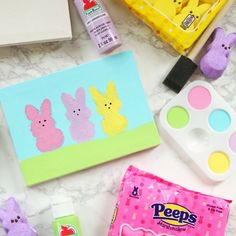 various crafts and supplies are laid out on the counter for making easter bunnies with peeps