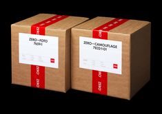 two cardboard boxes with red ribbon on the top and bottom, one for zero - camouflage