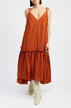 A sunny day dress is tiered in ruffles and rendered in an earthy hue. 44 1/2" length V-neck V-back Adjustable tie straps Cotton lining 60% polyester, 40% viscose Hand wash, line dry Imported V-neck Tiered Sundress For Day Out, Flowy V-neck Summer Tiered Dress, Chic Tiered V-neck Summer Dress, Feminine V-neck Tiered Summer Dress, Beach-ready Cotton Mini Length Tiered Dress, Tiered Midi Dress, Day Dress, Anniversary Sale, Sweater And Shorts