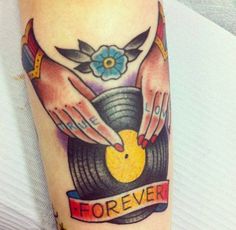 two hands holding a record with the word forever on it and an orange rubber duck