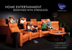 a group of people sitting on top of orange recliners in a living room